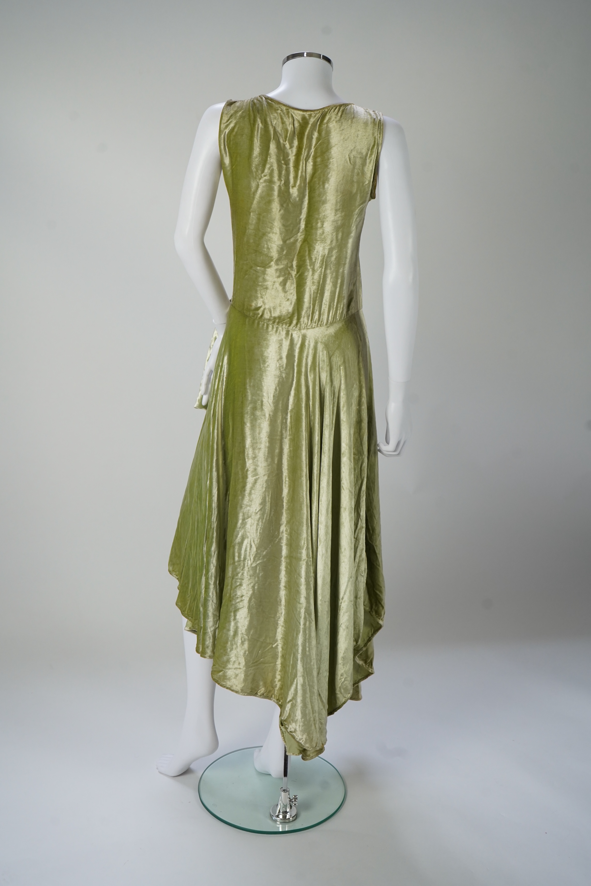 A late 1920’s early 30’s green panne silk velvet evening dress, bias cut, with large diamanté ornamentation and bow on the hip, bust 36 inches, length 55inches. Condition - there is a small hole on the front near arm hol